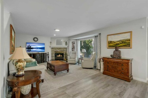 112 Hidden Vale Place Nw, Calgary, AB - Indoor Photo Showing Living Room With Fireplace