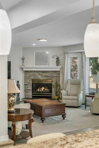 112 Hidden Vale Place Nw, Calgary, AB - Indoor Photo Showing Living Room With Fireplace