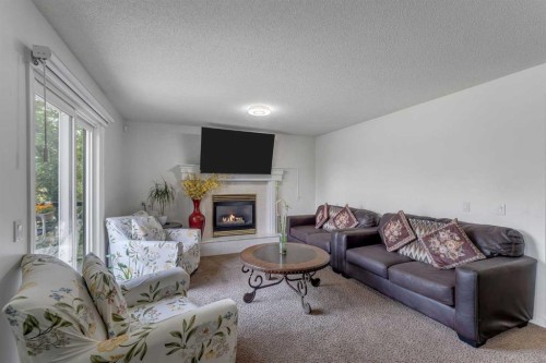 280140 Township Road 241A, Chestermere, AB - Indoor Photo Showing Living Room With Fireplace