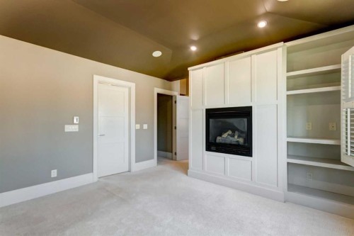 51 Aspen Meadows Green Sw, Calgary, AB - Indoor Photo Showing Other Room With Fireplace