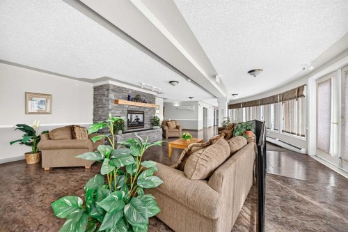 3425-3000 Millrise Point Sw, Calgary, AB - Indoor Photo Showing Living Room With Fireplace