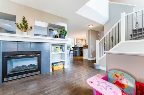 99 Springbluff Boulevard Sw, Calgary, AB - Indoor Photo Showing Living Room With Fireplace