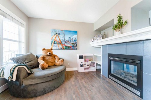 99 Springbluff Boulevard Sw, Calgary, AB - Indoor Photo Showing Living Room With Fireplace