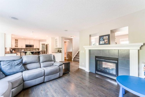 99 Springbluff Boulevard Sw, Calgary, AB - Indoor Photo Showing Living Room With Fireplace