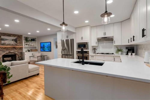 775 Strathcona Drive Sw, Calgary, AB - Indoor Photo Showing Kitchen With Fireplace With Double Sink With Upgraded Kitchen