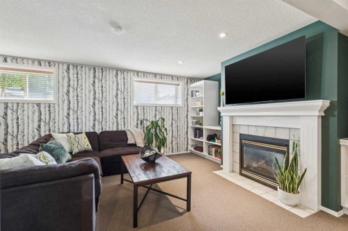 336 Mt Aberdeen Close Se, Calgary, AB - Indoor Photo Showing Living Room With Fireplace