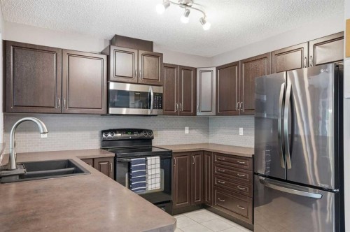 14 River Heights Crescent, Cochrane, AB - Indoor Photo Showing Kitchen With Double Sink With Upgraded Kitchen