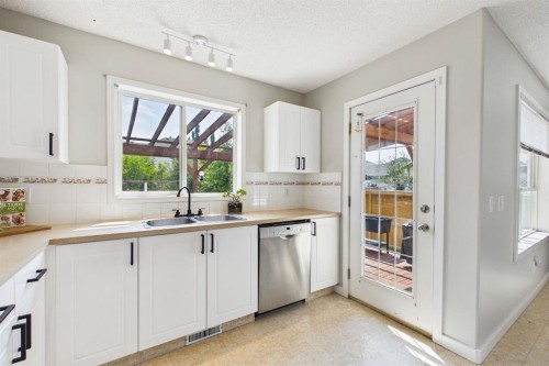 27 Bridlewood Park Sw, Calgary, AB - Indoor Photo Showing Kitchen With Double Sink