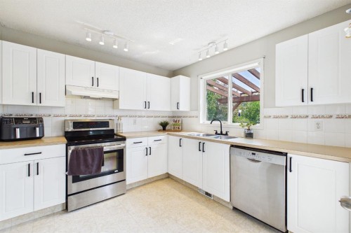 27 Bridlewood Park Sw, Calgary, AB - Indoor Photo Showing Kitchen With Stainless Steel Kitchen With Double Sink