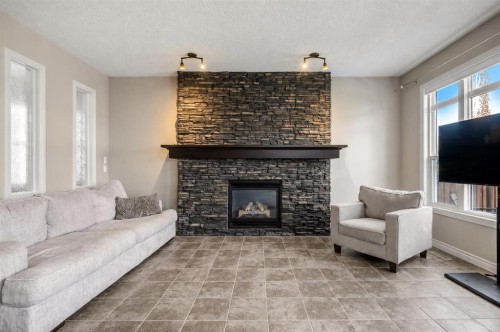 495 Cranford Drive Se, Calgary, AB - Indoor Photo Showing Living Room With Fireplace