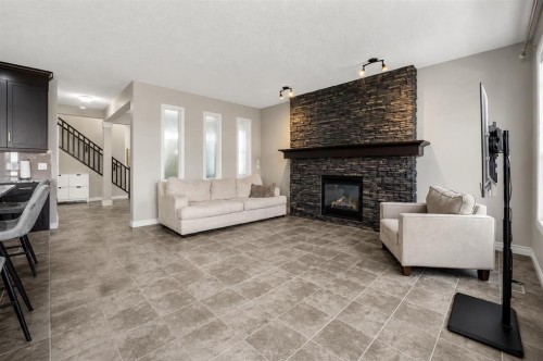 495 Cranford Drive Se, Calgary, AB - Indoor Photo Showing Living Room With Fireplace