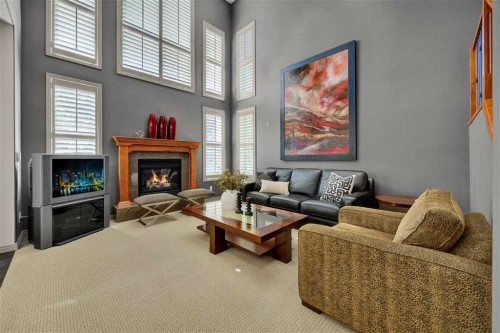 146 Springborough Point Sw, Calgary, AB - Indoor Photo Showing Living Room With Fireplace