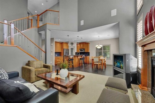 146 Springborough Point Sw, Calgary, AB - Indoor Photo Showing Living Room With Fireplace