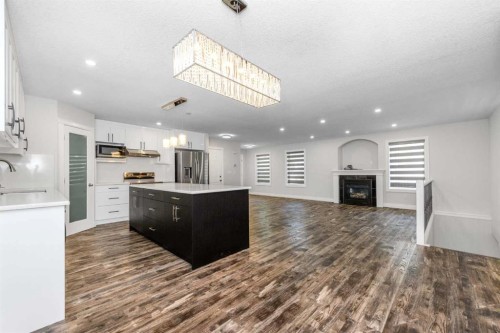 192 Cove Rise Rise, Chestermere, AB - Indoor Photo Showing Kitchen With Fireplace With Upgraded Kitchen