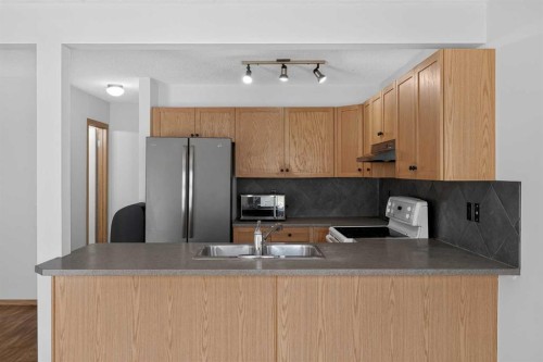 2337 Eversyde Avenue Sw, Calgary, AB - Indoor Photo Showing Kitchen With Double Sink