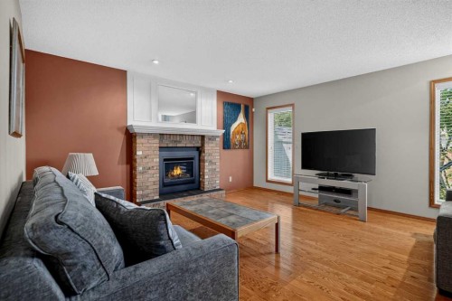 105 Riverview Court Se, Calgary, AB - Indoor Photo Showing Living Room With Fireplace