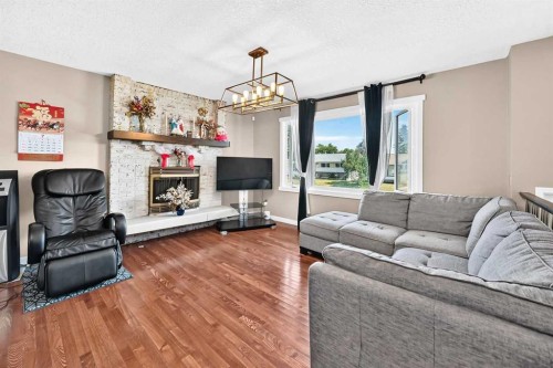 1823 65 Street Ne, Calgary, AB - Indoor Photo Showing Living Room With Fireplace