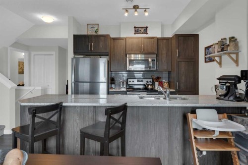 205-250 Fireside View, Cochrane, AB - Indoor Photo Showing Kitchen With Stainless Steel Kitchen With Double Sink