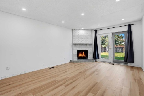 172 Templemont Drive Ne, Calgary, AB - Indoor Photo Showing Living Room With Fireplace