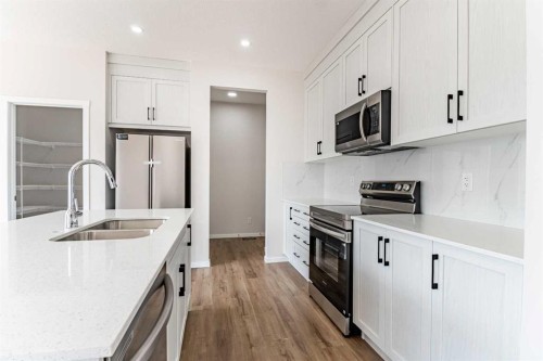 4041 Southwinds Way Sw, Airdrie, AB - Indoor Photo Showing Kitchen With Double Sink With Upgraded Kitchen