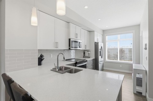 187 Legacy Common Se, Calgary, AB - Indoor Photo Showing Kitchen With Double Sink With Upgraded Kitchen