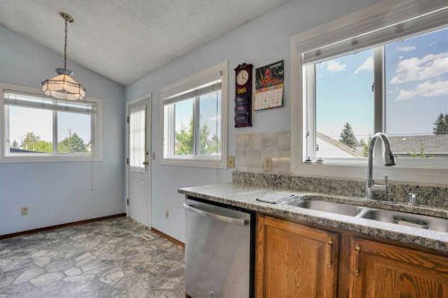 21 La Valencia Green Ne, Calgary, AB - Indoor Photo Showing Kitchen With Double Sink