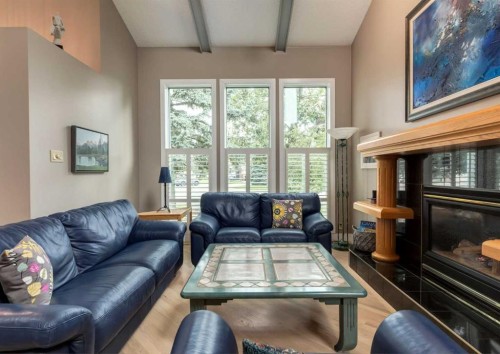 111 Hawksbrow Drive Nw, Calgary, AB - Indoor Photo Showing Living Room With Fireplace