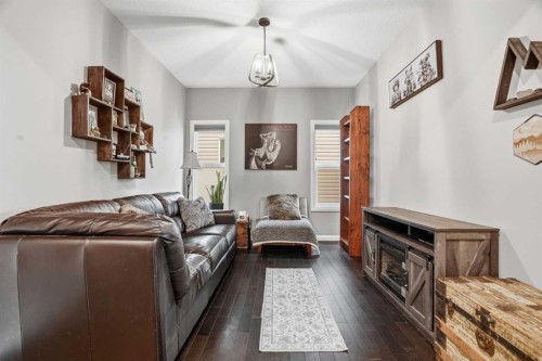 113 Sunset View, Cochrane, AB - Indoor Photo Showing Living Room With Fireplace