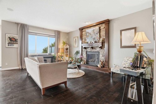 113 Sunset View, Cochrane, AB - Indoor Photo Showing Living Room With Fireplace