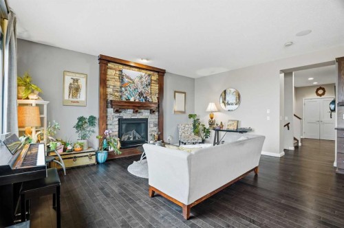 113 Sunset View, Cochrane, AB - Indoor Photo Showing Living Room With Fireplace