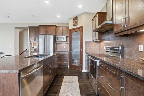 113 Sunset View, Cochrane, AB - Indoor Photo Showing Kitchen With Stainless Steel Kitchen With Upgraded Kitchen