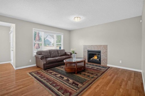 189 Bridleridge View Sw, Calgary, AB - Indoor Photo Showing Living Room With Fireplace