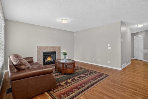 189 Bridleridge View Sw, Calgary, AB - Indoor Photo Showing Living Room With Fireplace