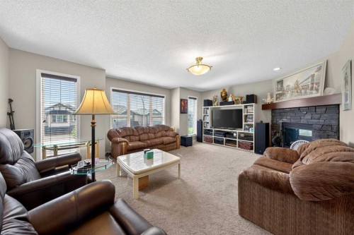 27 Panatella Row Nw, Calgary, AB - Indoor Photo Showing Living Room With Fireplace