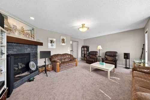 27 Panatella Row Nw, Calgary, AB - Indoor Photo Showing Living Room With Fireplace