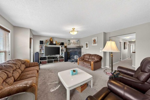 27 Panatella Row Nw, Calgary, AB - Indoor Photo Showing Living Room With Fireplace