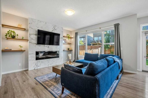 114 Crestbrook Way Sw, Calgary, AB - Indoor Photo Showing Living Room With Fireplace
