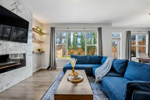 114 Crestbrook Way Sw, Calgary, AB - Indoor Photo Showing Living Room With Fireplace