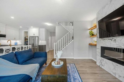 114 Crestbrook Way Sw, Calgary, AB - Indoor Photo Showing Living Room With Fireplace