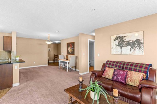 7202-403 Mackenzie Way Sw, Airdrie, AB - Indoor Photo Showing Living Room
