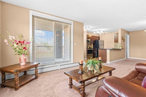 7202-403 Mackenzie Way Sw, Airdrie, AB - Indoor Photo Showing Living Room