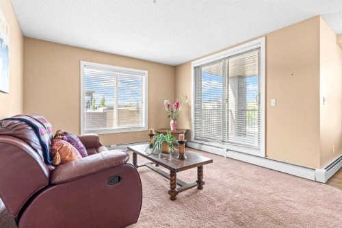 7202-403 Mackenzie Way Sw, Airdrie, AB - Indoor Photo Showing Living Room