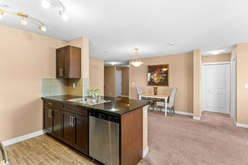 7202-403 Mackenzie Way Sw, Airdrie, AB - Indoor Photo Showing Kitchen With Double Sink