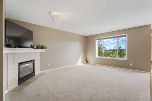 13 Tuscany Springs Circle Nw, Calgary, AB - Indoor Photo Showing Living Room With Fireplace
