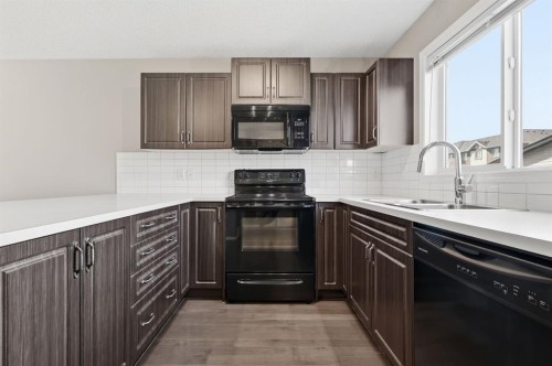 4008 New Brighton Grove Se, Calgary, AB - Indoor Photo Showing Kitchen With Double Sink
