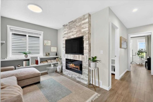 90 Savoy Landing Se, Calgary, AB - Indoor Photo Showing Living Room With Fireplace