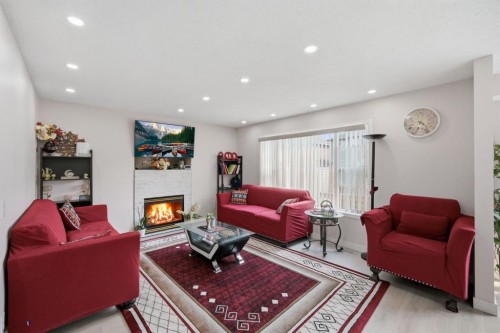 54 Saddlecreek Crescent Ne, Calgary, AB - Indoor Photo Showing Living Room With Fireplace