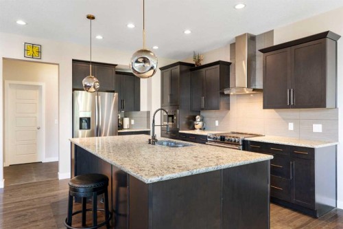 434 River Heights Drive, Cochrane, AB - Indoor Photo Showing Kitchen With Stainless Steel Kitchen With Double Sink With Upgraded Kitchen