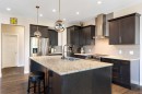 434 River Heights Drive, Cochrane, AB  - Indoor Photo Showing Kitchen With Stainless Steel Kitchen With Double Sink With Upgraded Kitchen 