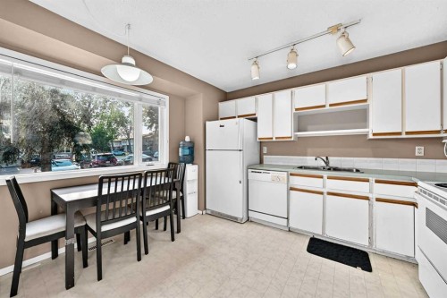 13-123 Queensland Drive Se, Calgary, AB - Indoor Photo Showing Kitchen With Double Sink